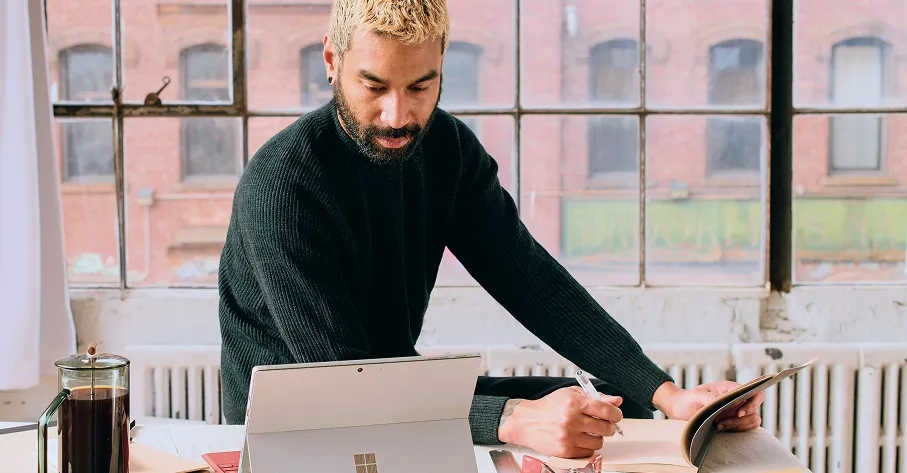 Person by fence looking thoughtful